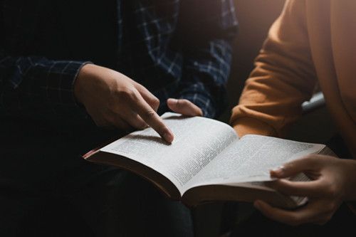 Two Christians discussing and studying the Bible.